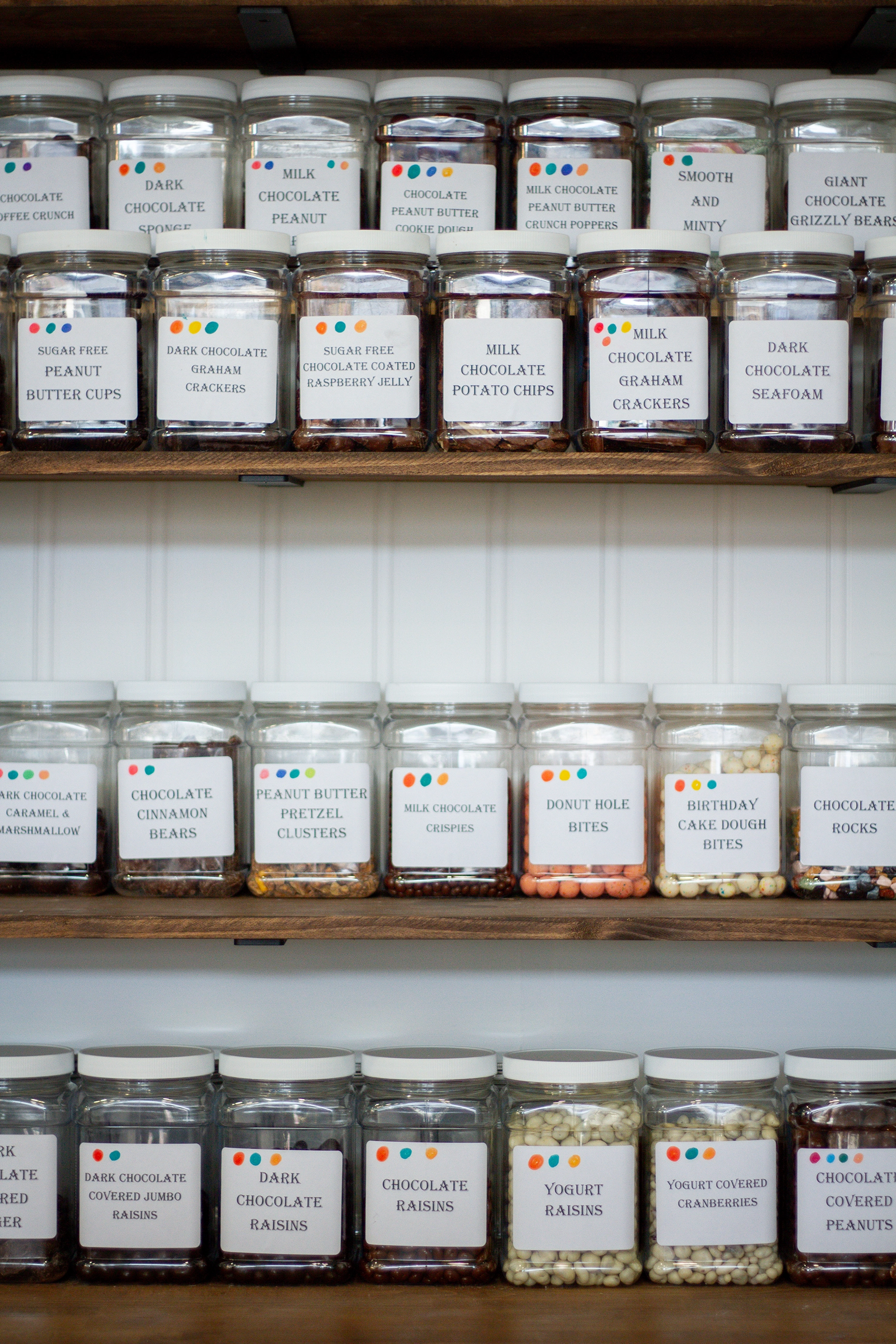 Jars of classic penny candy on wooden shelves