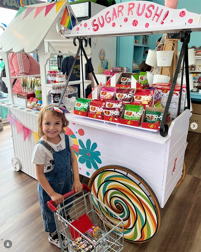 a young customer shpos for candy near a cart filled with jellybeans